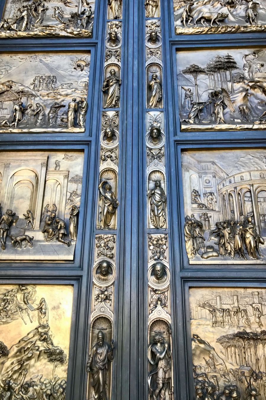 A photo of the 'Doors of Paradise' at Grace Cathedral in San Francisco, featuring intricate bronze depictions of biblical scenes. These doors are replicas of Lorenzo Ghiberti's original masterpieces, which are now preserved in a museum in Florence, Italy.
